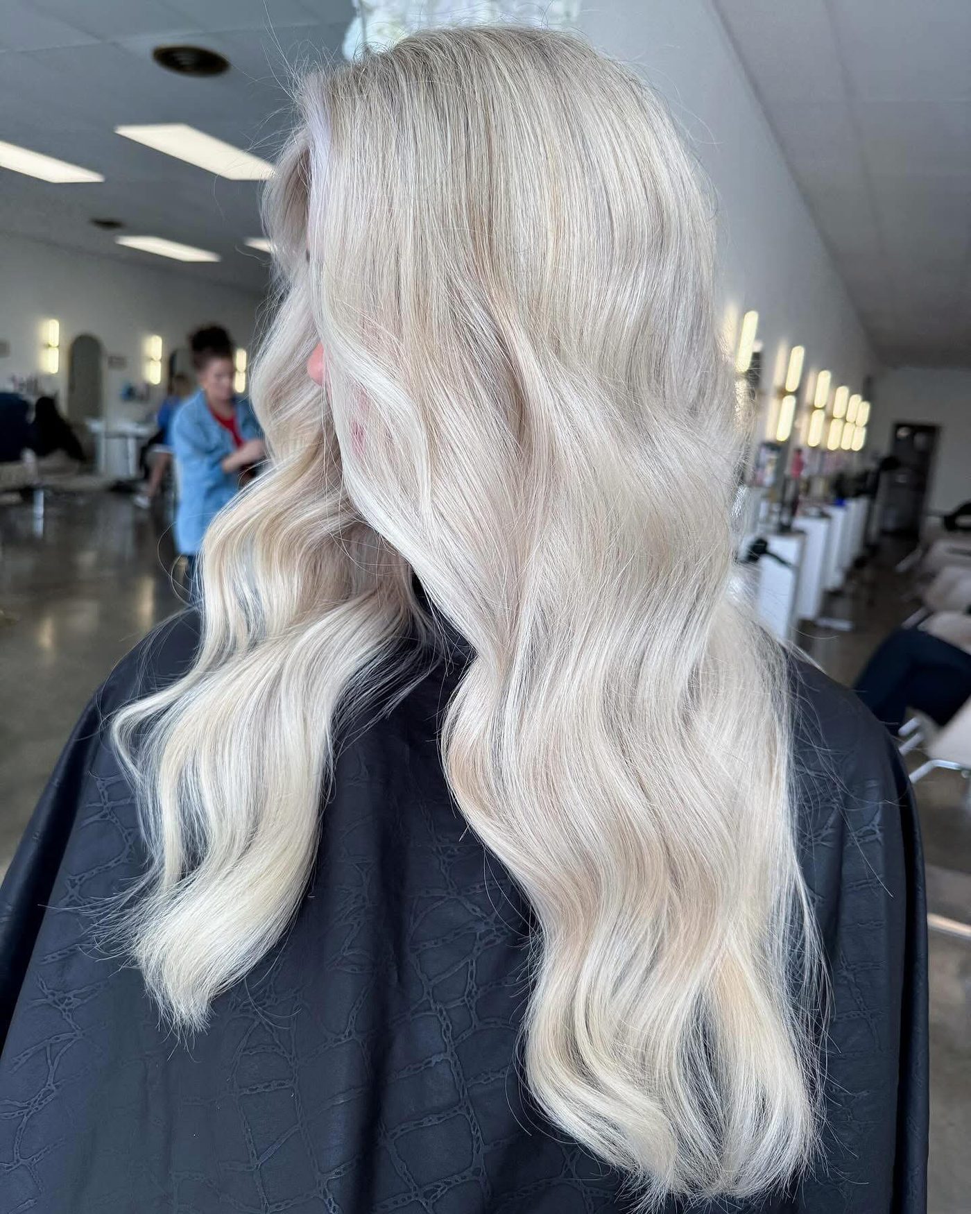 Long platinum blonde waves, side view