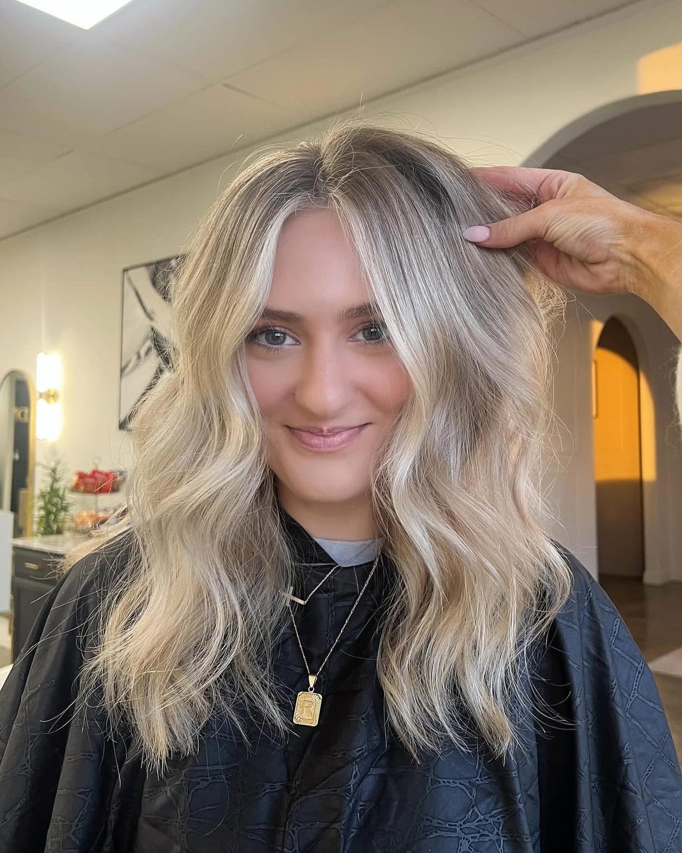 Rooted blonde blowout with volume