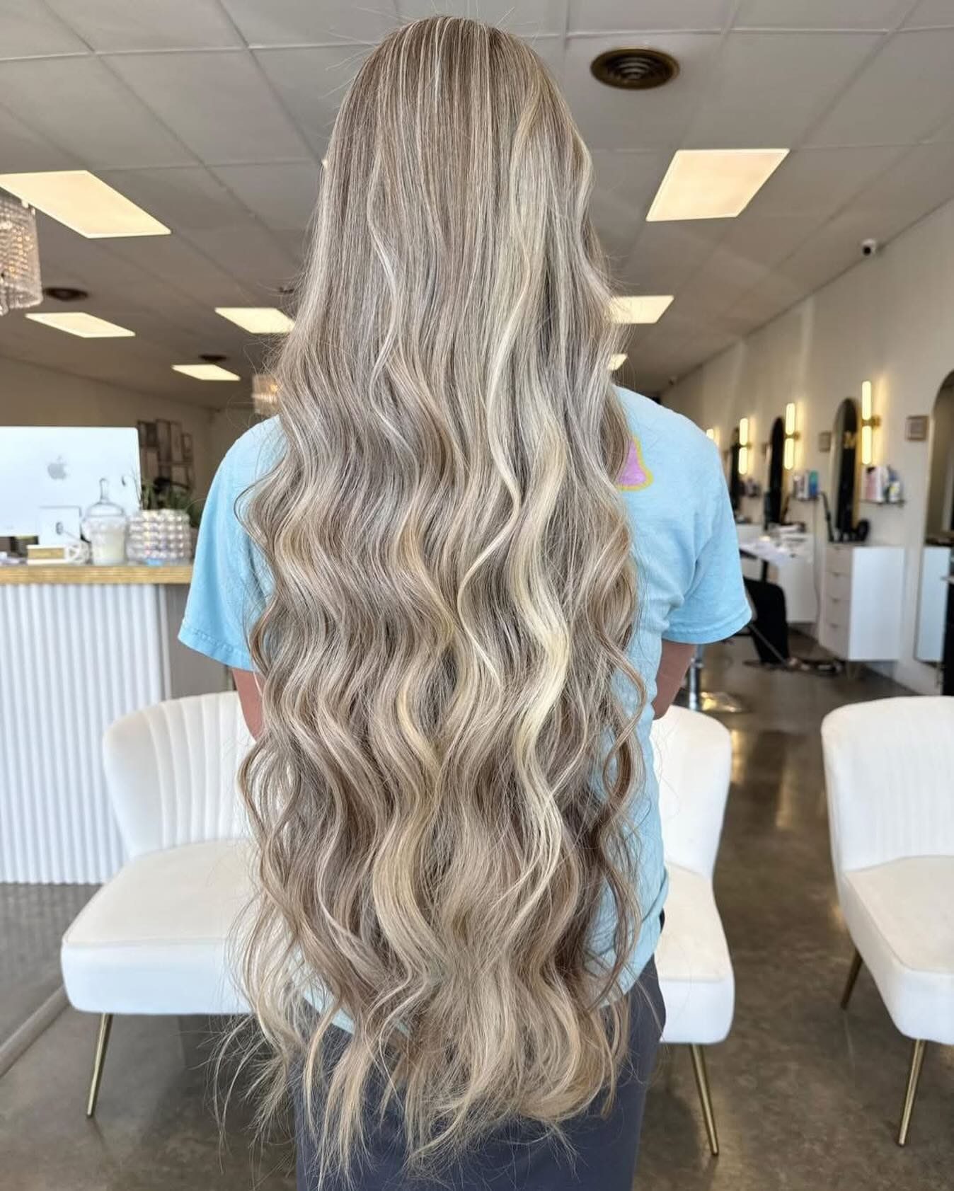 Extra-long blonde waves styled at ADM Hair Studio, back view