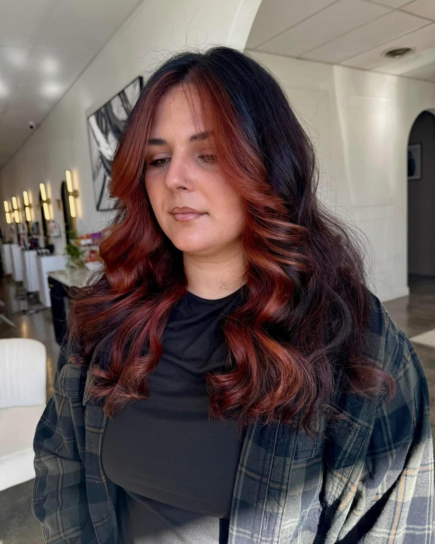 Red face-frame over black curls